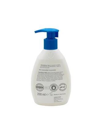 White bottle with blue pump on a white background