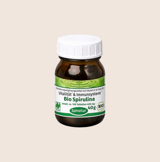 Bottle of Bio Spirulina with a white cap on a beige background